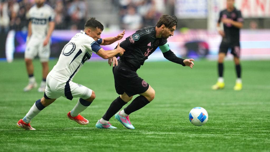 Lionel Messi of Inter Miami CF controls the ball whilst under pressure from Andres Cubas of the Vancouver Whitecaps