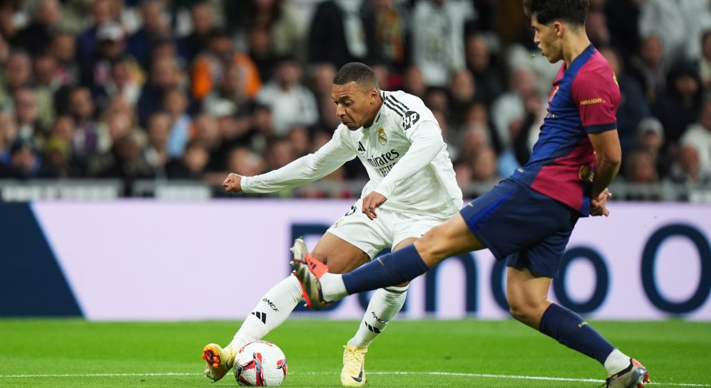 Kylian Mbappe and Pau Cubarsi playing at the Santiago Bernabeu Stadium.